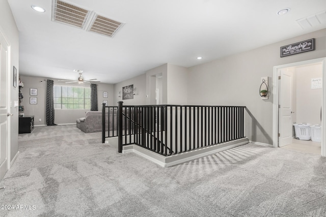 hallway featuring light colored carpet