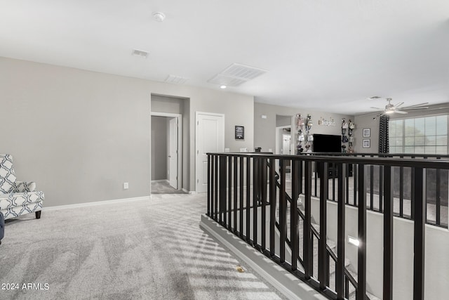 hallway with light colored carpet