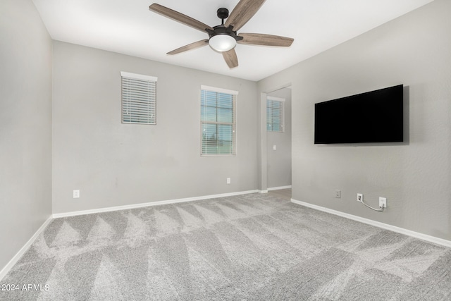 spare room featuring ceiling fan and carpet flooring