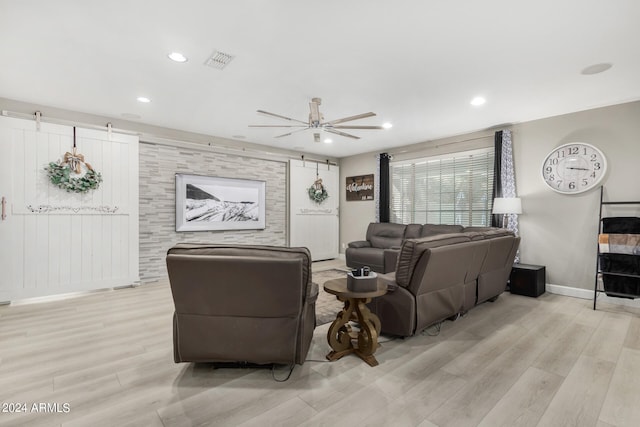 living room with ceiling fan and light hardwood / wood-style floors