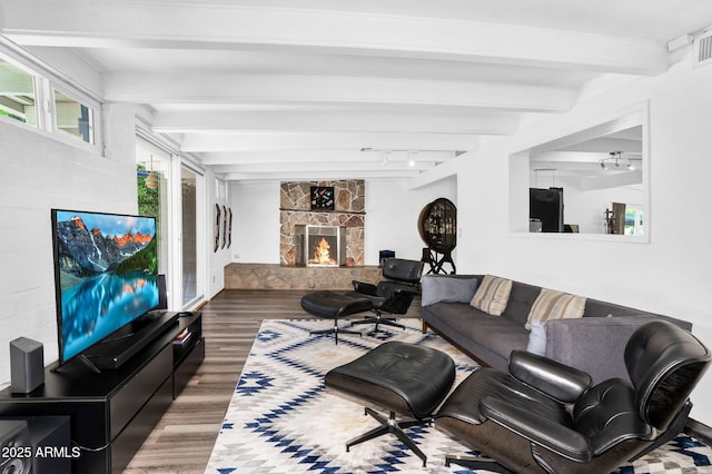 1029 E Palo Verde Dr, Phoenix, AZ 85014 - living room featuring wood finished floors, beamed ceiling, track lighting, and a fireplace