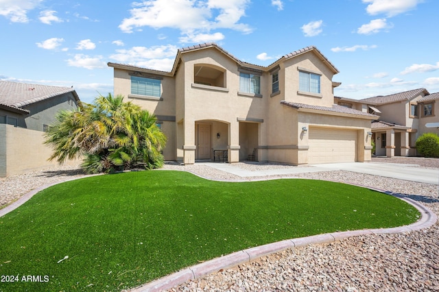 mediterranean / spanish home with a garage and a front lawn