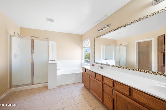 bathroom with tile patterned floors, shower with separate bathtub, and vanity