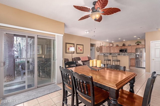 dining space with light tile patterned floors and ceiling fan