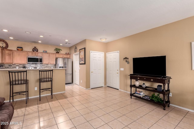 interior space with light tile patterned floors, recessed lighting, and baseboards