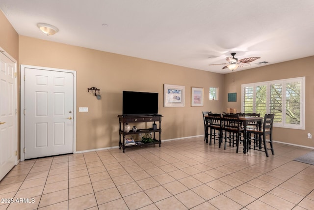 dining room with light tile patterned floors, visible vents, baseboards, and ceiling fan