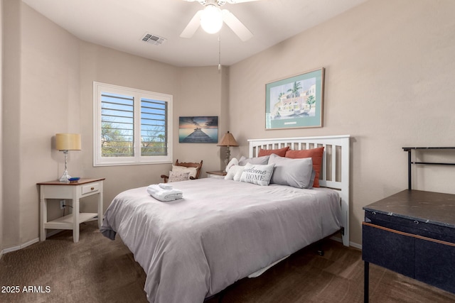 bedroom featuring baseboards, visible vents, dark carpet, and ceiling fan