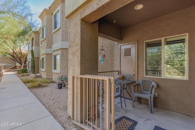 doorway to property featuring stucco siding