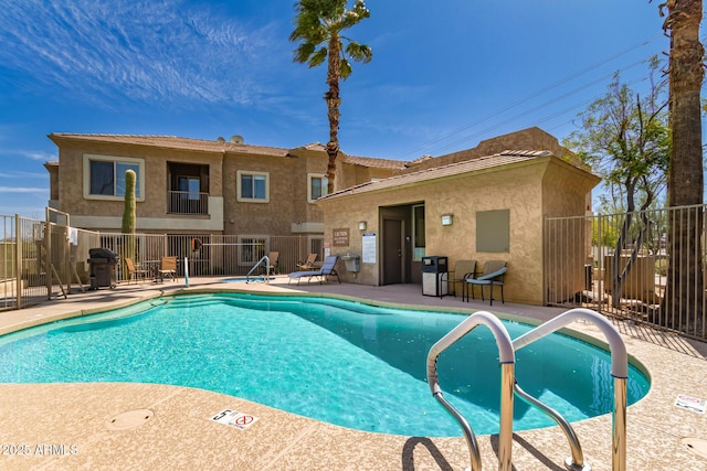 pool featuring fence, a grill, and a patio area