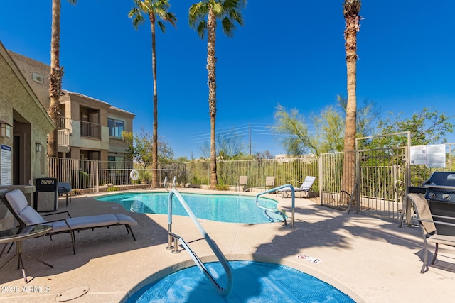 community pool featuring a patio and fence