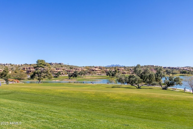 view of property's community with a yard and a water view