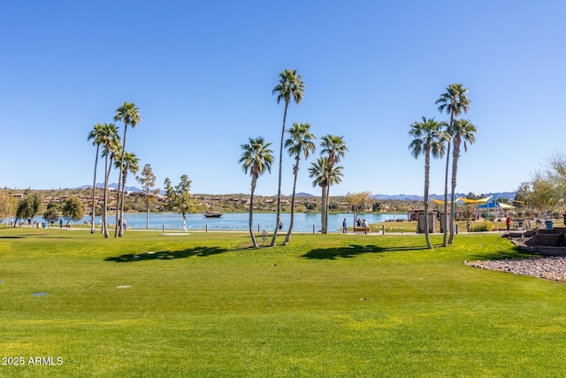 view of community with a lawn and a water view