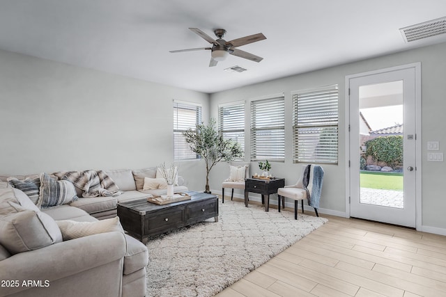 living room with ceiling fan and light wood-type flooring