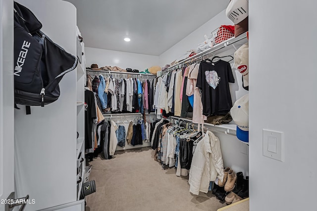 spacious closet featuring light carpet