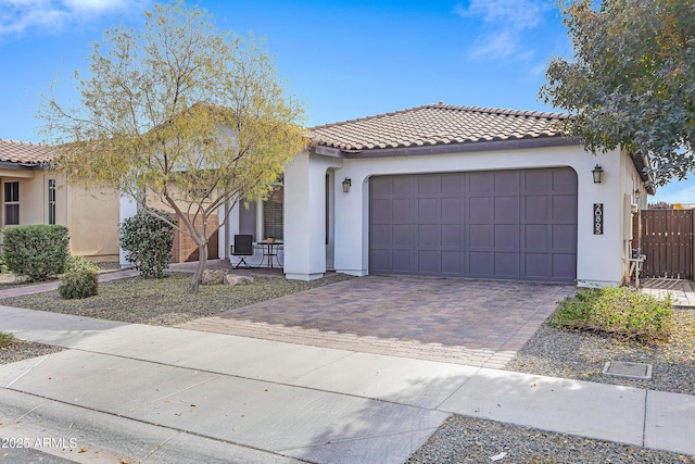 mediterranean / spanish home with a garage