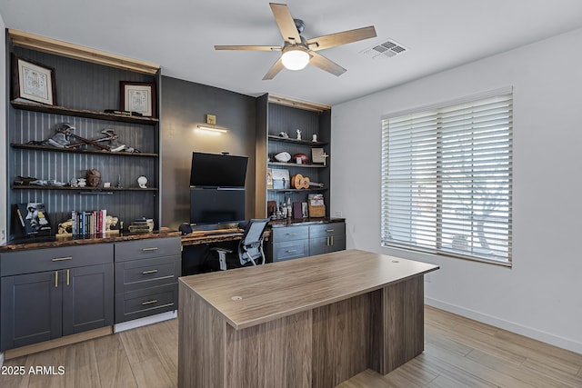 office space with ceiling fan and light hardwood / wood-style flooring