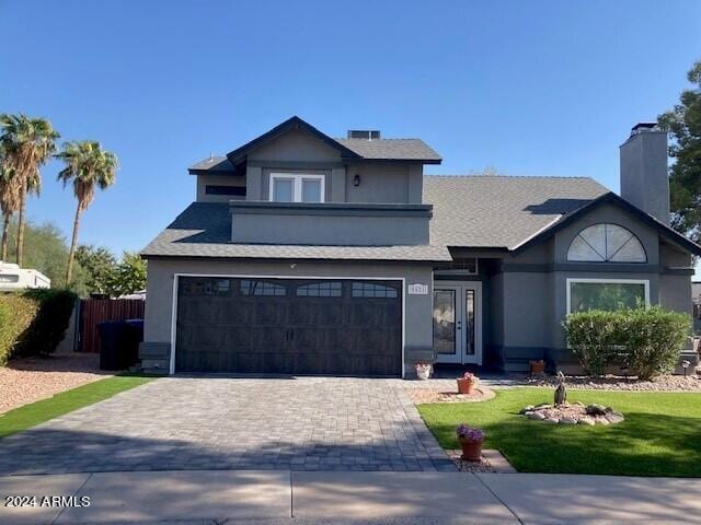 view of front of property featuring a garage and a front yard