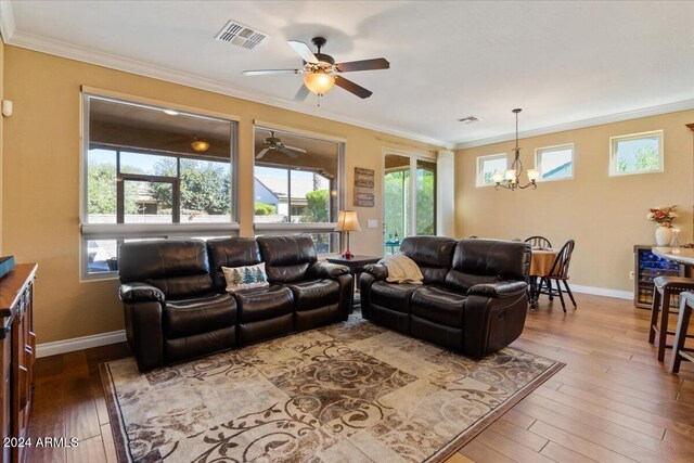 856 E Harmony Way, San Tan Valley, AZ 85140 - living area with a chandelier, a ceiling fan, crown molding, hardwood / wood-style flooring, and baseboards