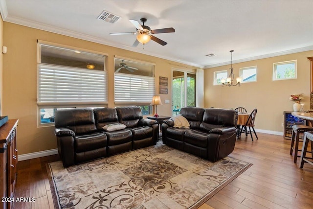 856 E Harmony Way, San Tan Valley, AZ 85140 - living area featuring a chandelier, a ceiling fan, hardwood / wood-style flooring, crown molding, and baseboards