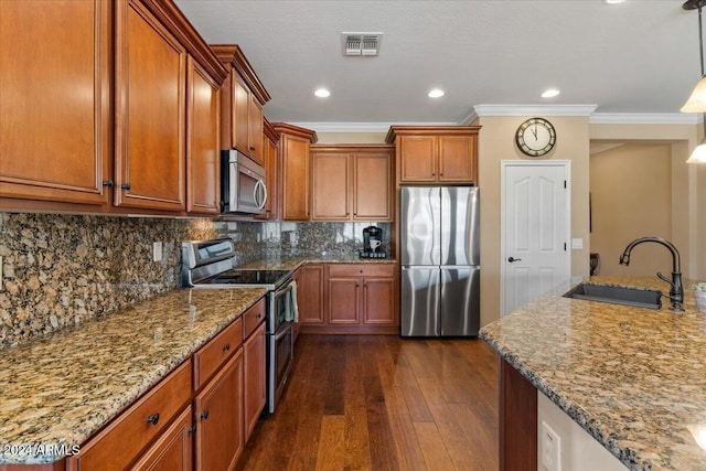 856 E Harmony Way, San Tan Valley, AZ 85140 - kitchen with stainless steel appliances, a sink, ornamental molding, brown cabinetry, and dark wood-style floors