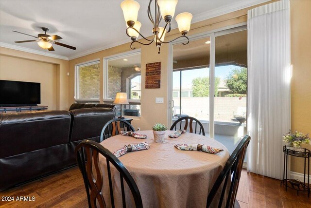 856 E Harmony Way, San Tan Valley, AZ 85140 - dining area with dark wood-type flooring, a chandelier, a ceiling fan, and crown molding