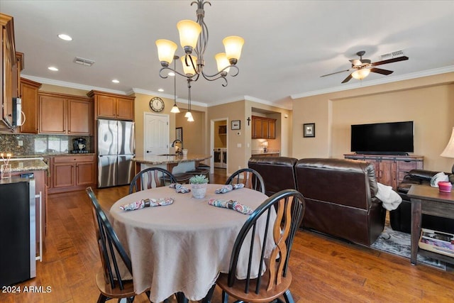 856 E Harmony Way, San Tan Valley, AZ 85140 - dining space with wood finished floors, ceiling fan, ornamental molding, a chandelier, and recessed lighting