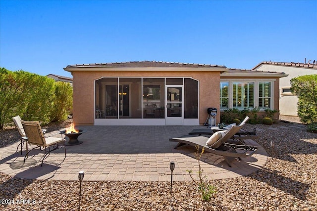 856 E Harmony Way, San Tan Valley, AZ 85140 - back of house featuring a sunroom, an outdoor fire pit, stucco siding, and a patio