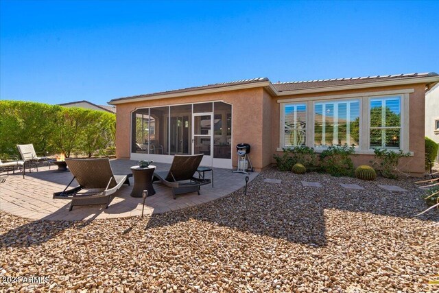 856 E Harmony Way, San Tan Valley, AZ 85140 - back of house featuring stucco siding, a sunroom, a patio area, and a tiled roof