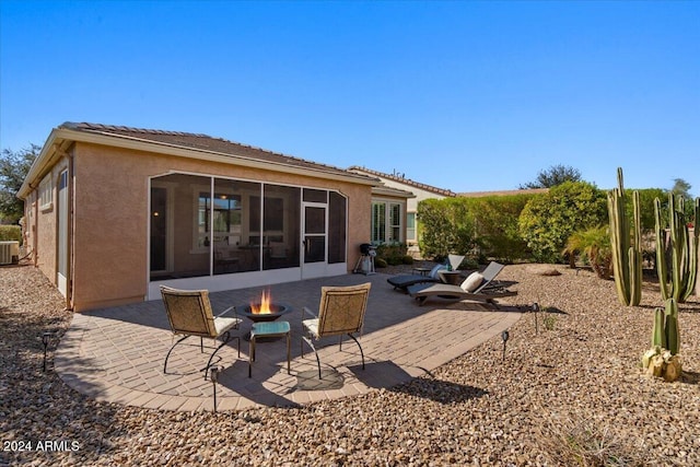 856 E Harmony Way, San Tan Valley, AZ 85140 - rear view of house with an outdoor fire pit, stucco siding, a patio, and a sunroom