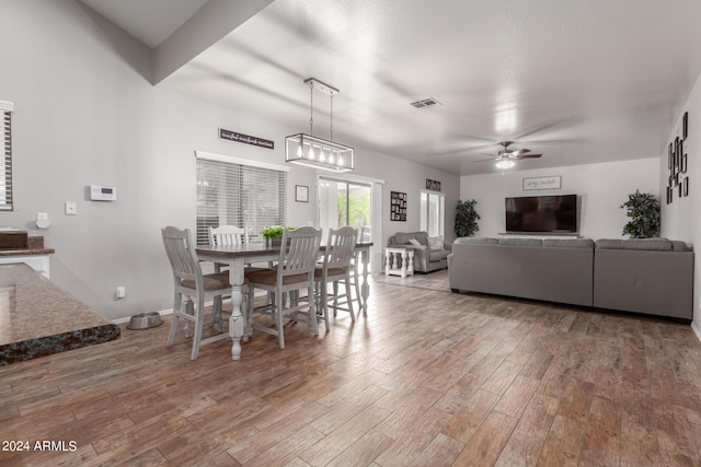 dining space featuring ceiling fan, wood finished floors, visible vents, and baseboards