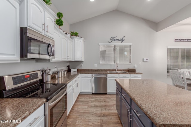 kitchen featuring white cabinets, stainless steel appliances, and a sink