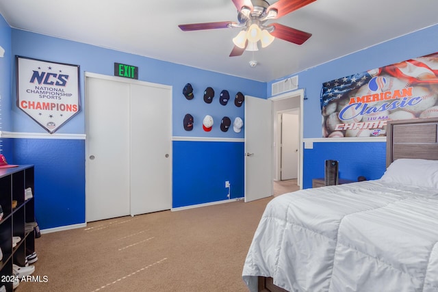 carpeted bedroom featuring baseboards, a closet, visible vents, and a ceiling fan