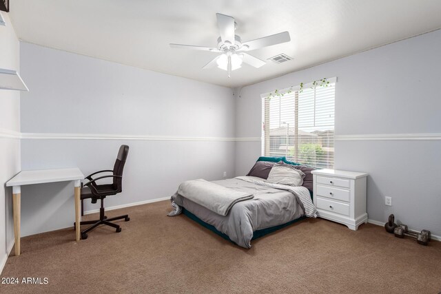 carpeted bedroom with a ceiling fan, visible vents, and baseboards