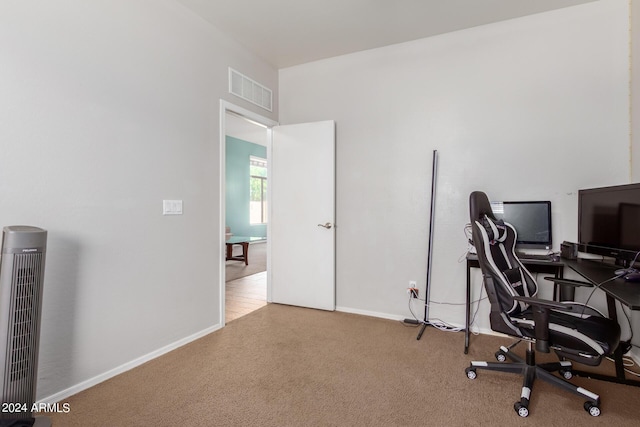 carpeted office featuring visible vents and baseboards