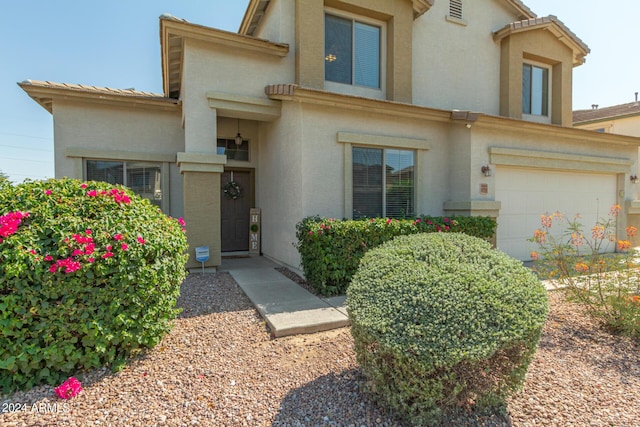 view of front facade with an attached garage and stucco siding