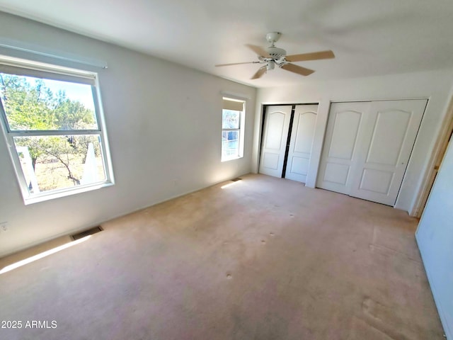 513 W Sherwood Dr, Payson, AZ 85541 - unfurnished bedroom featuring two closets, ceiling fan, light carpet, and visible vents