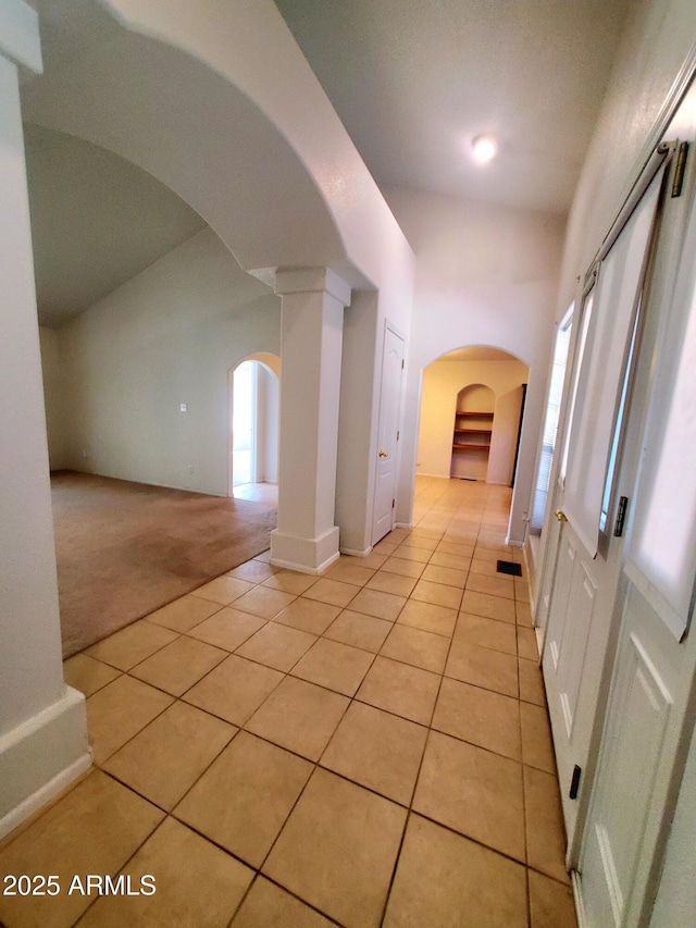 513 W Sherwood Dr, Payson, AZ 85541 - hall featuring light carpet, arched walkways, light tile patterned floors, and a healthy amount of sunlight