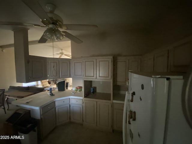 kitchen featuring white fridge, kitchen peninsula, and ceiling fan