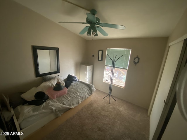 carpeted bedroom with ceiling fan and vaulted ceiling