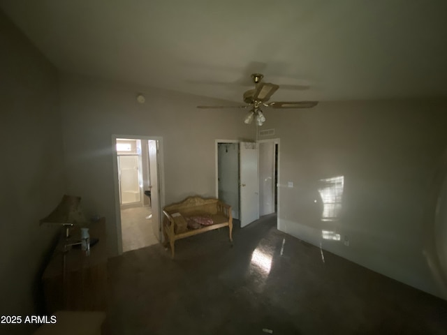 unfurnished bedroom featuring ceiling fan, ensuite bathroom, and dark colored carpet