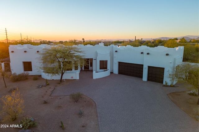 pueblo revival-style home with a garage