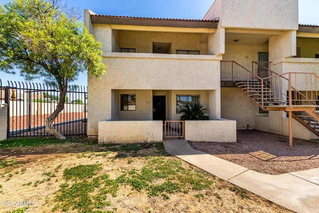 11026 N 28th Dr Unit 81, Phoenix, AZ 85029 - townhome / multi-family property with stairs, stucco siding, a balcony, and a gate