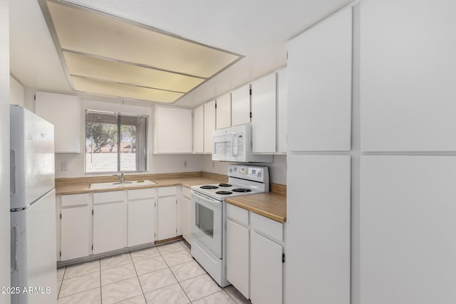 11026 N 28th Dr Unit 81, Phoenix, AZ 85029 - kitchen featuring white appliances, light tile patterned floors, and white cabinetry