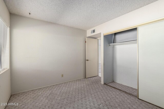 11026 N 28th Dr Unit 81, Phoenix, AZ 85029 - unfurnished bedroom featuring carpet floors, a textured ceiling, and a closet