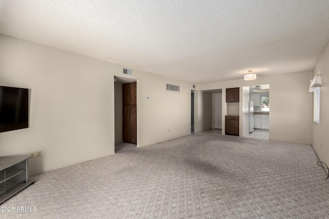 11026 N 28th Dr Unit 81, Phoenix, AZ 85029 - unfurnished living room featuring light colored carpet and a textured ceiling