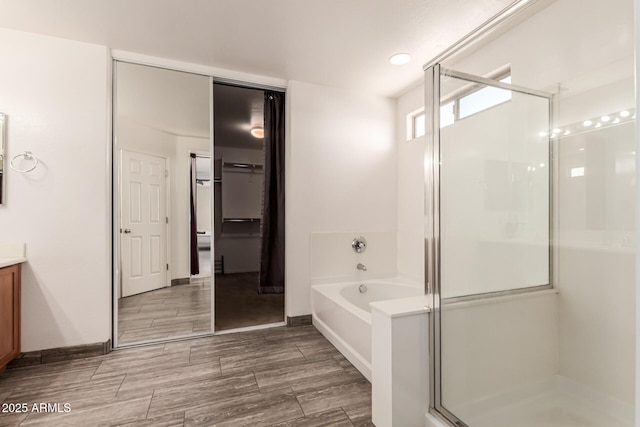 466 N 10th Pl, Coolidge, AZ 85128 - bathroom with a shower stall, vanity, a garden tub, and a closet