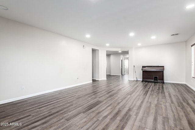 466 N 10th Pl, Coolidge, AZ 85128 - unfurnished living room with dark wood-type flooring and recessed lighting