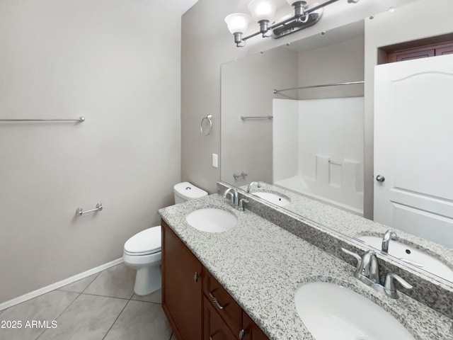 bathroom featuring toilet, tile patterned flooring, and a sink