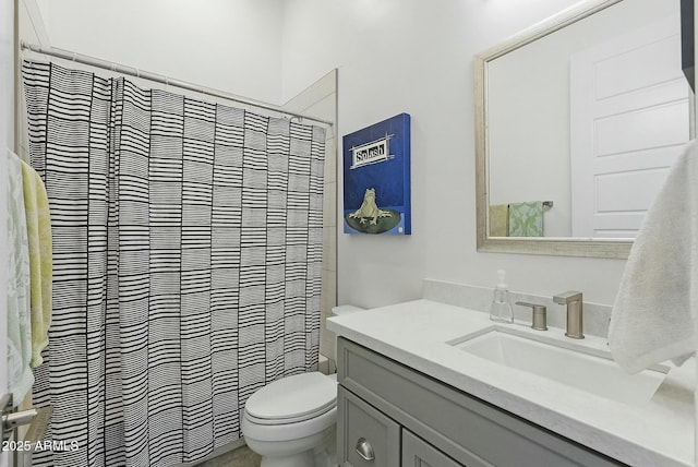 bathroom featuring vanity, toilet, and curtained shower