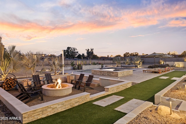 patio terrace at dusk with an outdoor fire pit